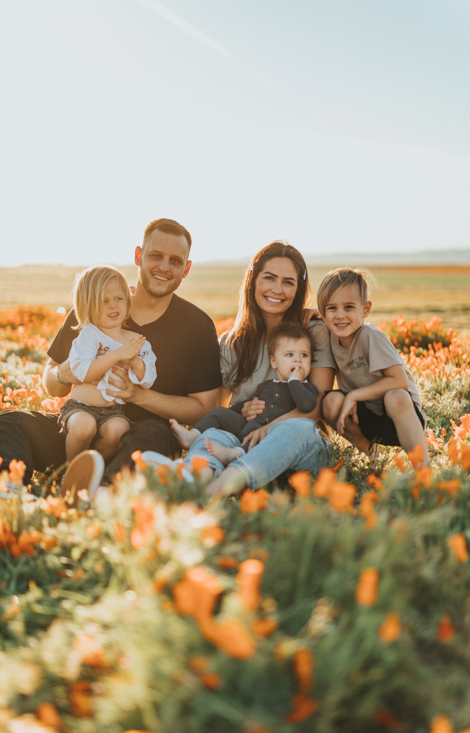 smiling family in a field