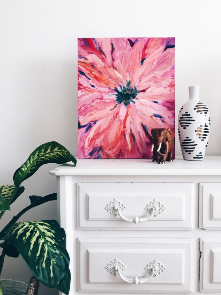 pink flower canvas on a white chest of drawers