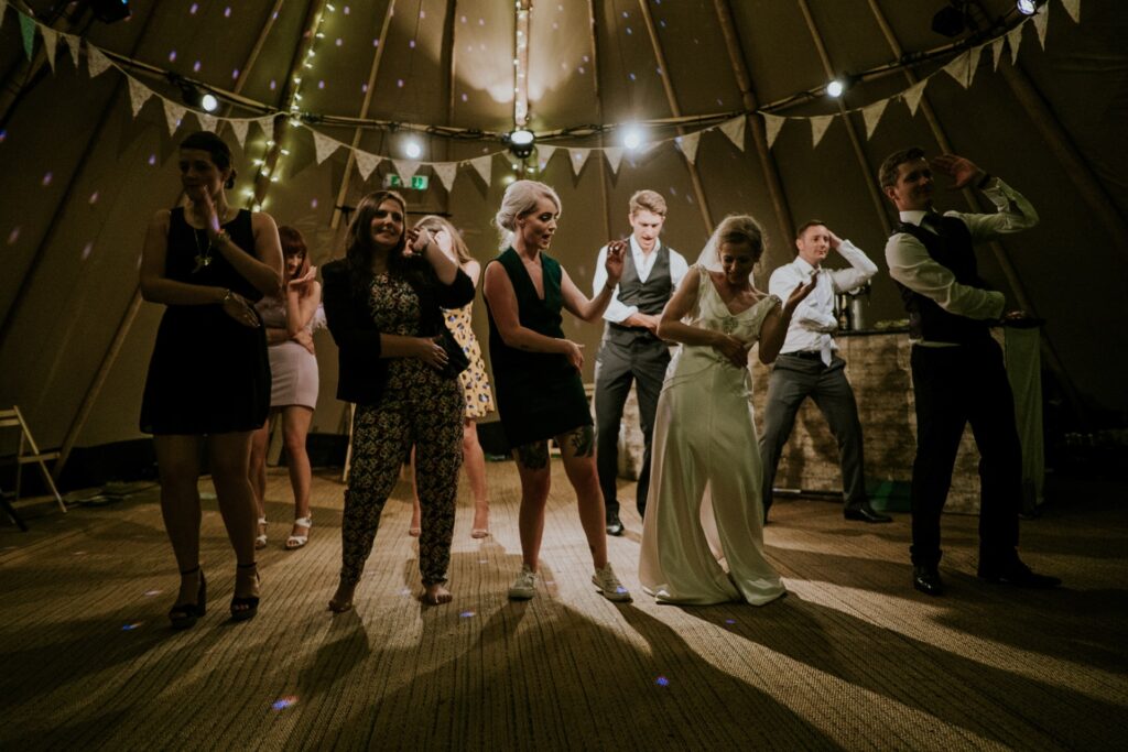 group of people dancing at a wedding night do