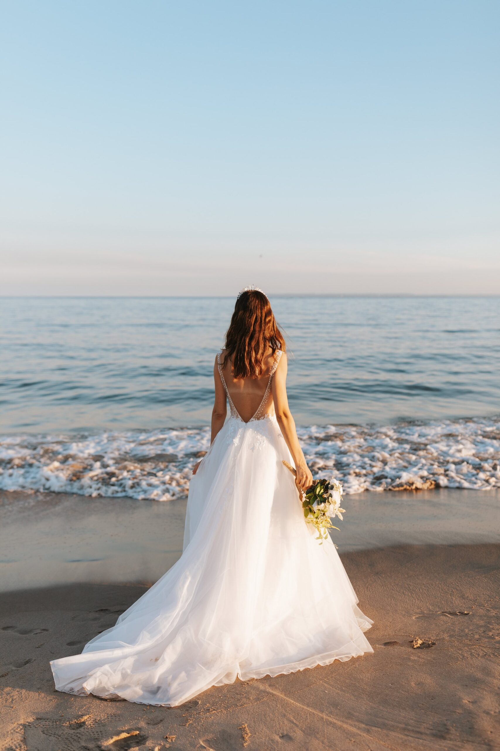 bride on the beach looking out to see