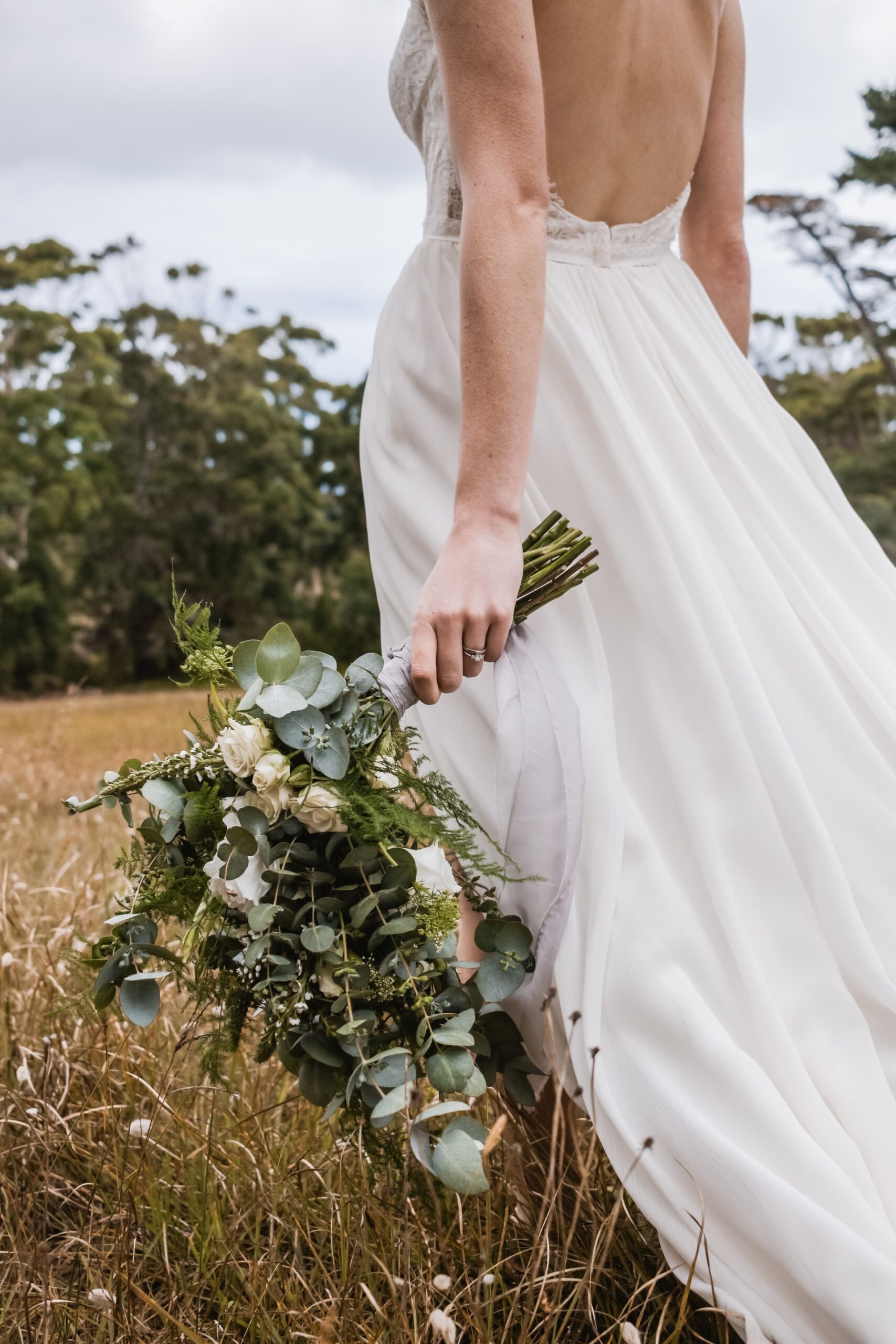 woman holding a bouquet at her side