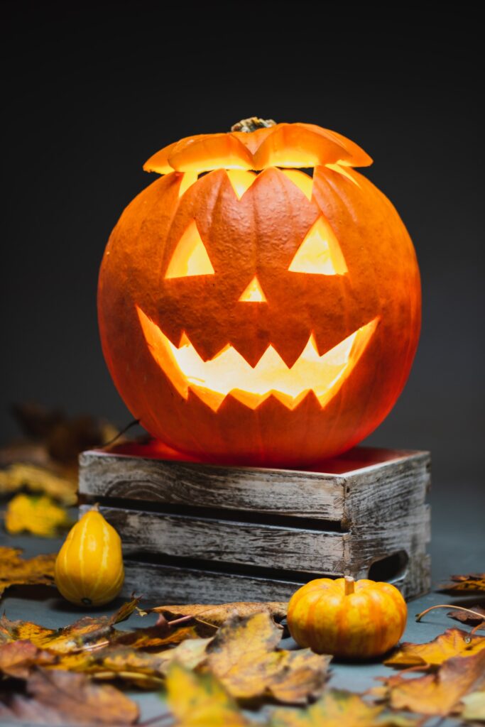 Halloween activities in Grimsby - jack o latern lit and posed on some old looking books