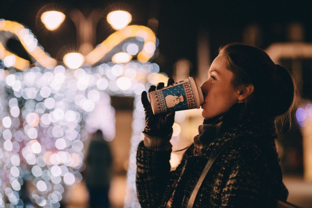 woman sipping coffee at christmas market. image for Cleethorpes Christams Market