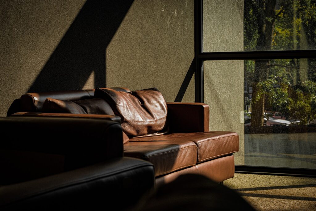 leather couch and dark green wall