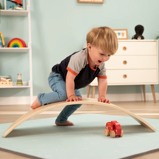Child playing on wooden toy